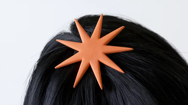 extreme close-up of an eight-pointed clay-orange spark hair clip in black hair against white, high-key white paper, one clay-orange #D97757 accent as the only colour, soft shadowless light, no text, no letters, no logos